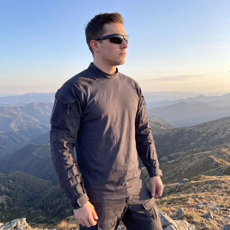 Navy blue tactical combat shirt outdoor mountain scene male model front view