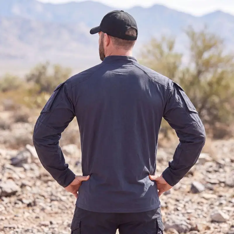 Dark navy tactical combat shirt back view male model desert mountain terrain